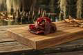 Dried beef strips on a wooden cutting board with a rustic background